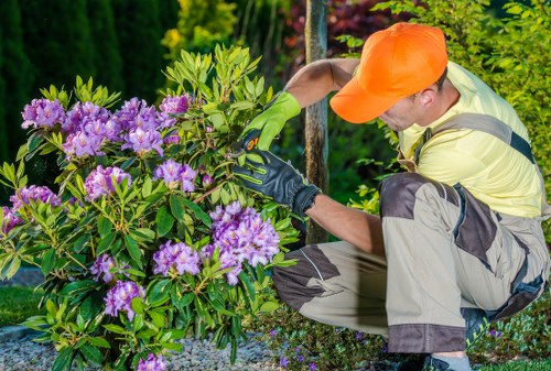 Company logo over garden tools representing commitment to anti-slavery