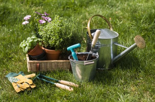 Gardener with tools in a Swiss Cottage front garden
