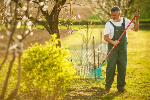 Communal courtyard tidy-up with gardeners carrying waste